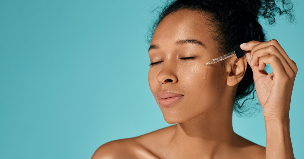 A woman applying oil to her dry, winter skin.