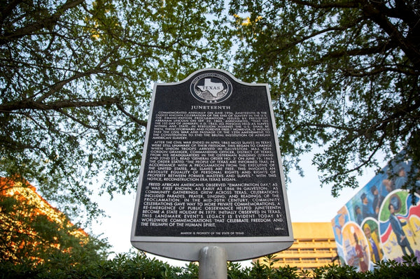 A plaque near the mural commemorating Juneteenth