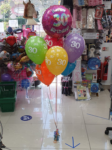 A bunch of six printed balloons, a pink 30th foil balloon and a weight