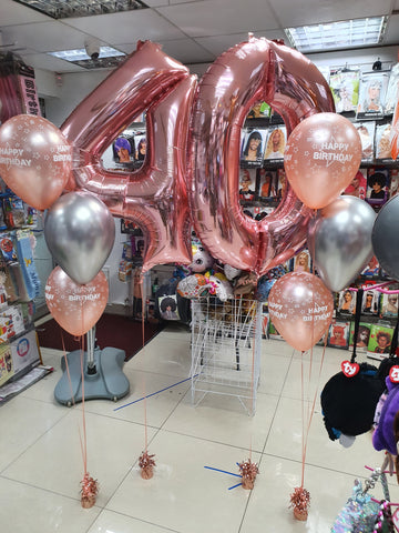 Two three balloon bouquets, a rose gold 4 and a rose gold 0