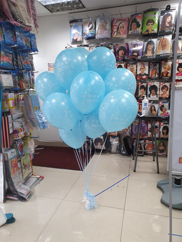 Two bunches of It's a Boy latex balloons on balloon weight