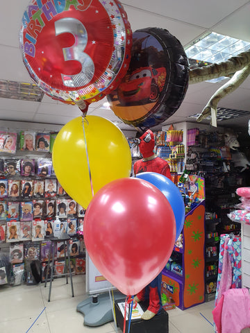 three brightly coloured latex helium balloons, one 3rd birthday and one Disney Cars foil balloon