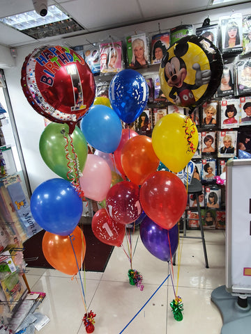 Brightly coloured rainbow 1st birthday balloons