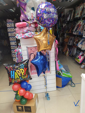 Brightly coloured boy's happy birthday balloons