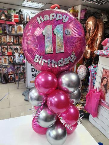Pink and silver 11th birthday balloon display