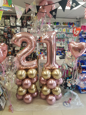 rose gold 21st birthday balloon columns and bouquets