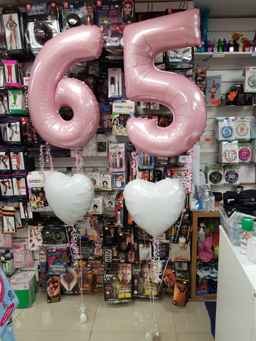 Pastel pink 65th number balloons with white heart balloons