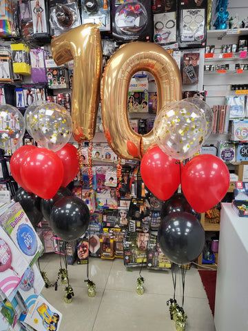 gold confetti, red and black three balloon bouquets with 70th gold numbers