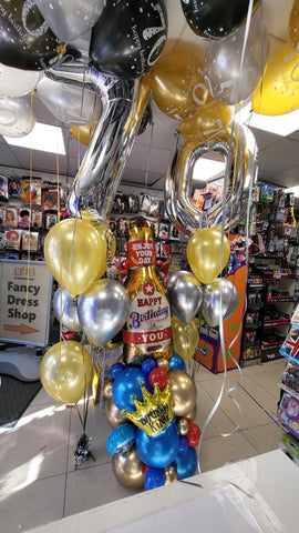 Black, gold and silver 70th birthday ceiling balloons, themed balloon stack and five balloon bouquets with foil numbers