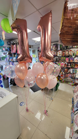 Rose gold and baby pink 11th birthday balloon display