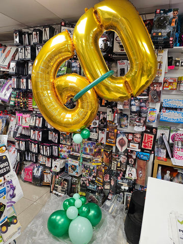 Gold and Green 60th birthday slanted balloon display