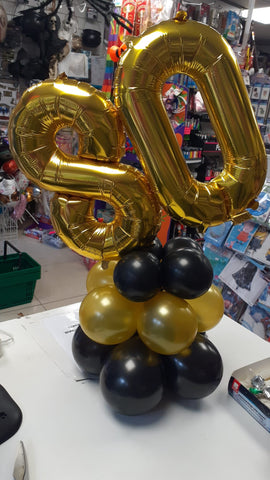 black and gold 80th birthday double number table centrepiece