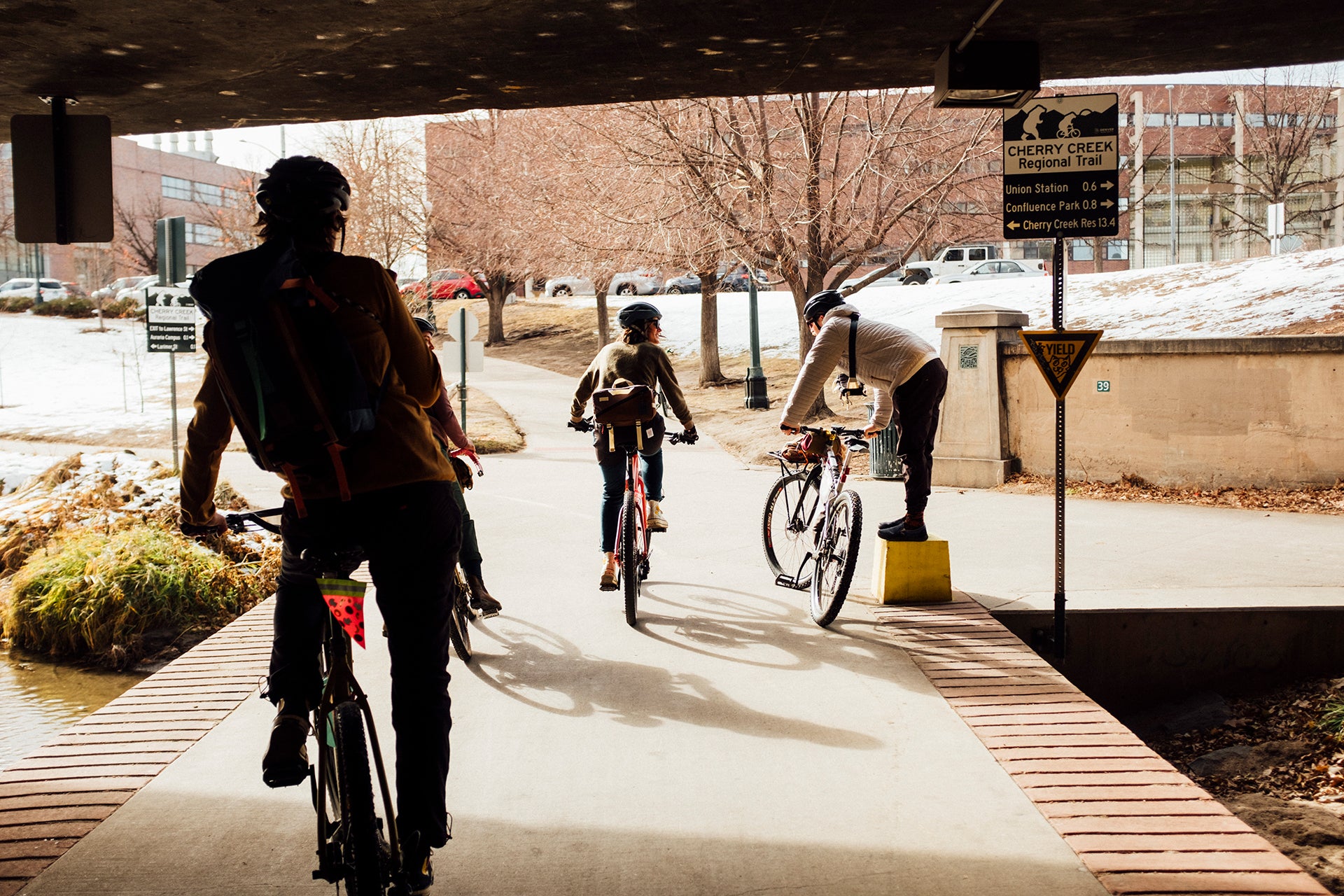 Friends biking under an overpass