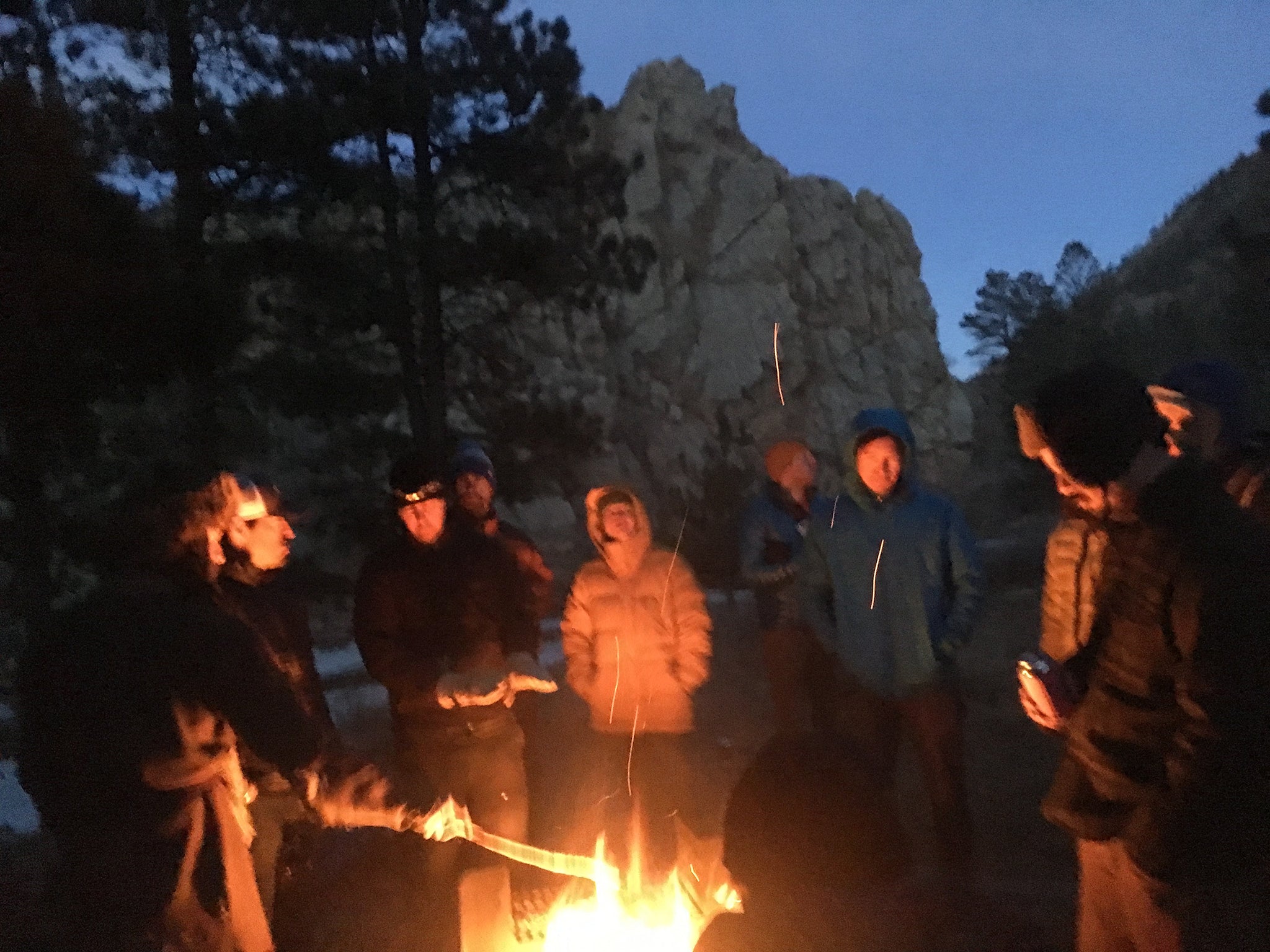 group of friends around campfire