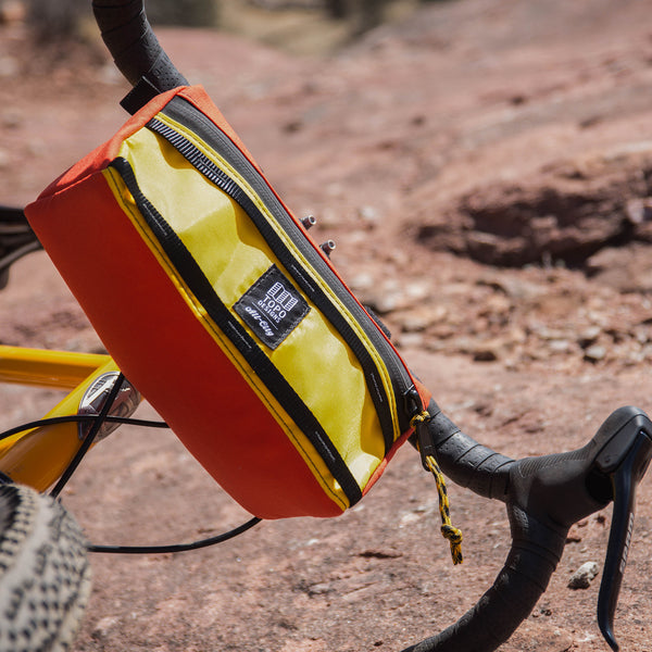 topo designs bike bag for handlebars with shoulder strap in yellow
