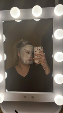mirror selfie of a girl wearing an led mask