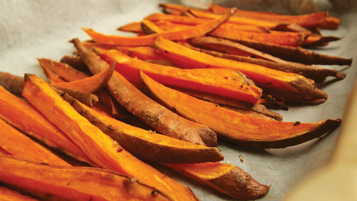 A pan with a row of roasted sliced sweet potato