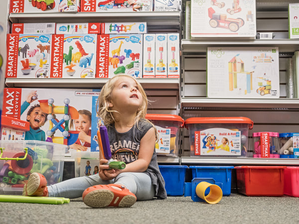 A young child playing with a building toy