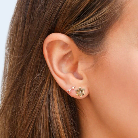 star stud earrings gold in an ear stack