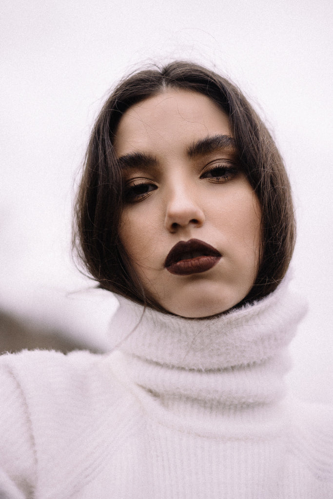 woman in a white turtleneck knit sweater