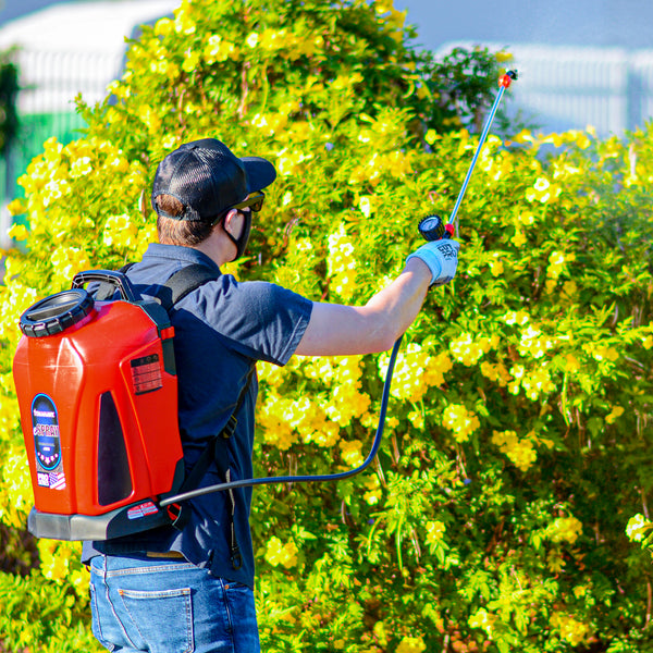 Man using Tomahawk's 4.75 Gallon Battery Powered Backpack Sprayer for Pest Control