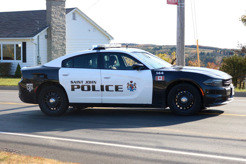 Saint John Police car parked on a street in the daytime. 