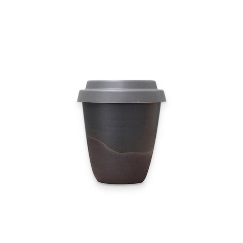 Arcadia Scott Ceramics' Travel Tumbler in Noir finish, the gently curved clay cup all dark greys and soft blacks with a pale grey silicon lid