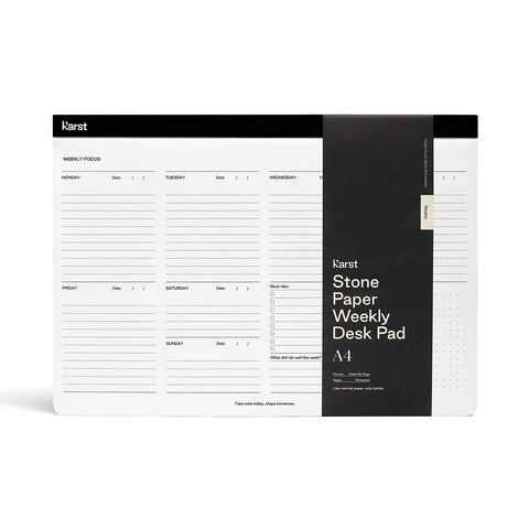 Karst Weekly Desk Pad | Milligram [img: a white rectangular pad with a black strip across the top. A black band wraps around the pad vertically on the right side, with white text reading Karst Stone Paper Weekly Desk Pad]