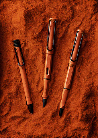 safari Anniversary terra red pens (ballpoint, fountain and rollerball) laid in an earthy red dust