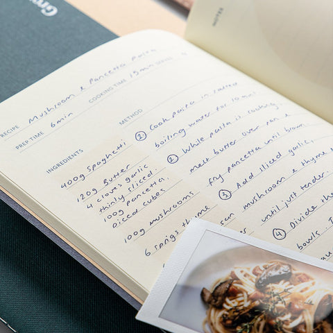 A Studio Milligram Cook Life Journal with a handwritten recipe for mushroom and pancetta pasta