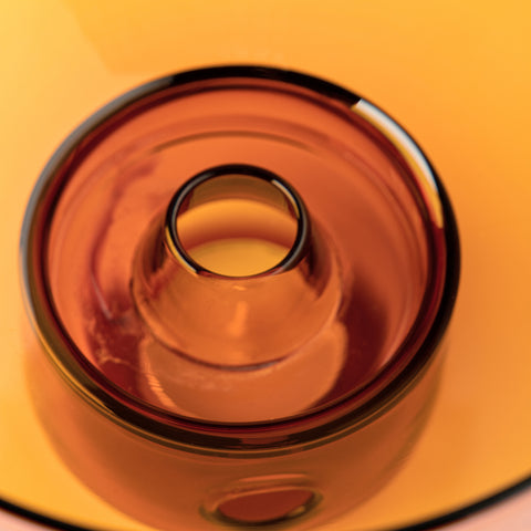A close-up view of Studio Milligram's Glass Oil Burner in Amber