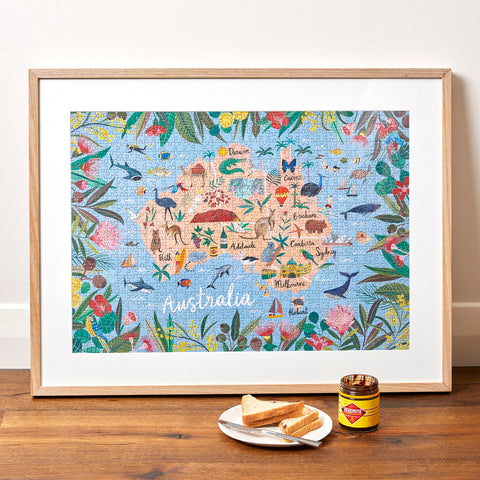 Journey of Something "Australia" puzzle, framed, with a jar of Vegemite and toast triangles in front ofit