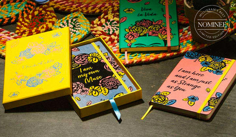 The three Moleskine Frida Kahlo notebooks, with pink, green and blue covers featuring Frida-style floral designs