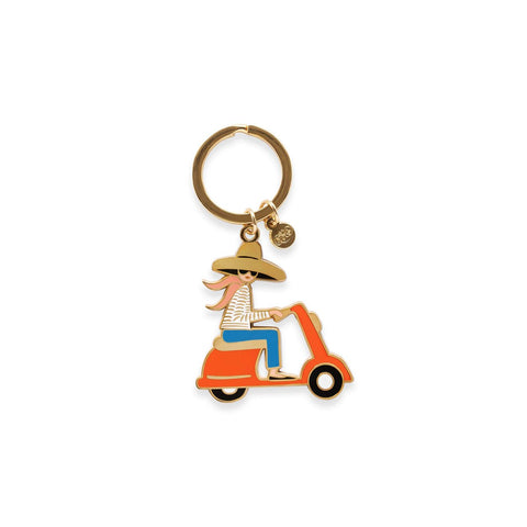 Rifle Paper Co.'s Scooter Enamel Keyring, featuring a cute design of a redheaded woman riding a Vespa-style scooter