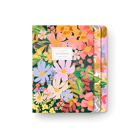 Rifle Paper Co.'s Marguerite Stitched Notebook Set features three notebooks (shown here overlapping one another) with bright floral designs with lots of pinks, blues, oranges and more