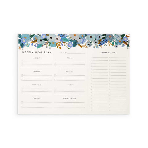 Rifle Paper Co. Weekly Meal Planner Notepad in Garden Party Blue - a large, landscape pad with room for each days' meals and a tear-off shopping list. The pad is decorated with illustrations of blue flowers along its top edge.