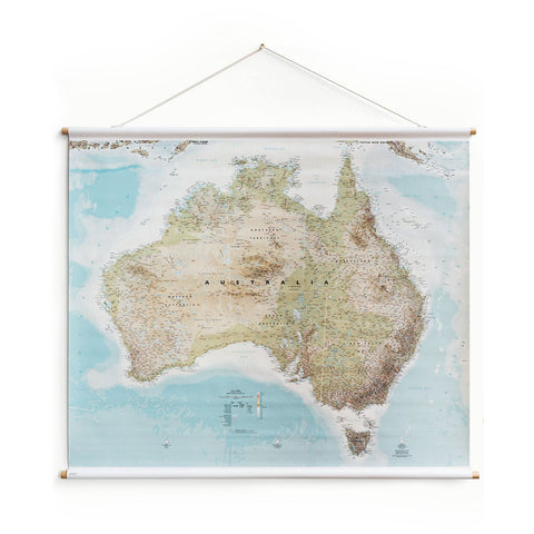 Studio Milligram Australia Wall Map, featuring a topographical map of the continent on a rectangular canvas supported by horizontal wooden poles