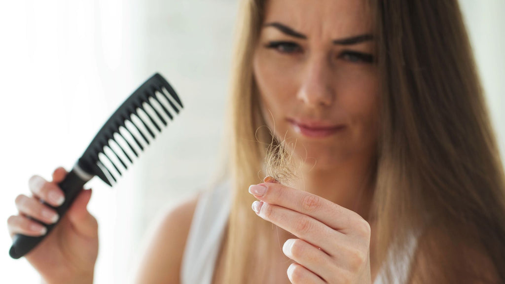 a woman seeing hair loss after combing