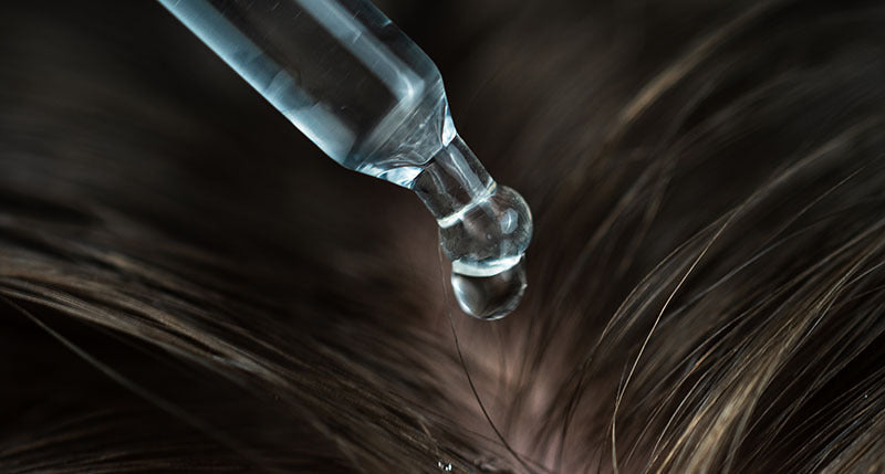 Hair growth serum woman applying