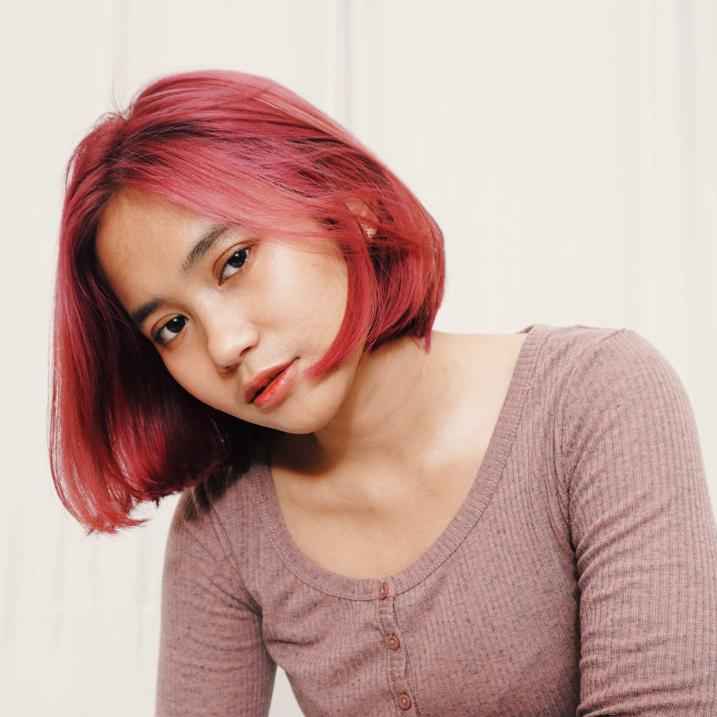 asian woman with dyed hair looking at camera