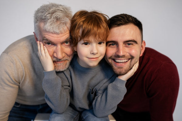 Two men and a kid smiling