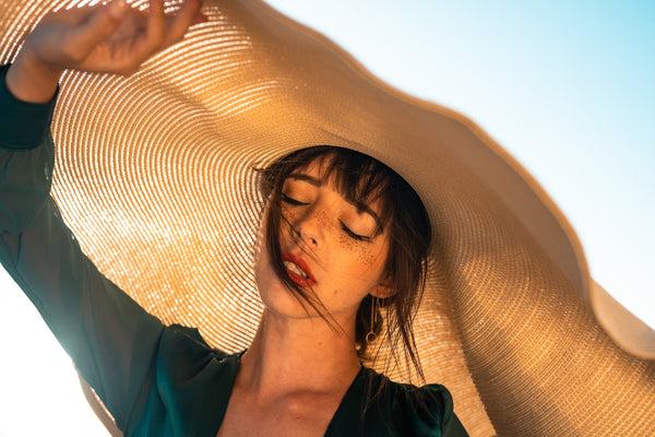 Woman with big hat to cover from UV rays