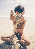 Boy dropping sand in the summer sun