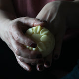 Woman rubbing hand balm over hands