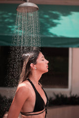 women in the shower outside with black bikini