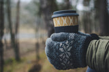 Woman wearing gloves holding coffee in Autumn