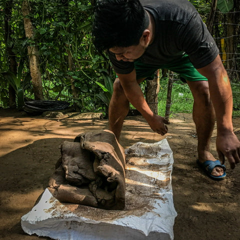 Santiago prepares the clay with a traditional foot massaging
