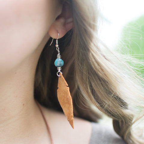 Leather feather turquoise earrings on woman