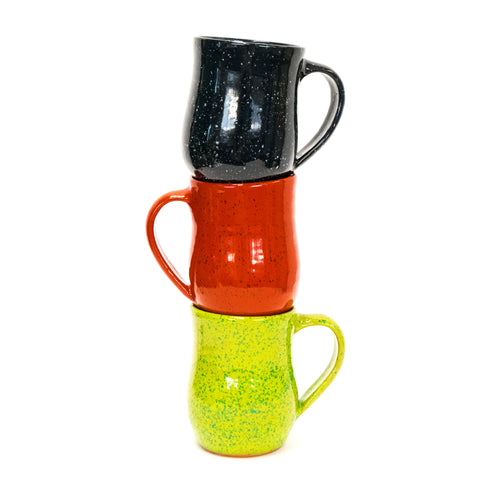 three colorful mugs stacked on each other