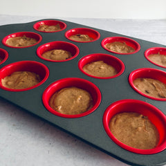 chocolate chip chai muffins using kimbala chai concentrate portioned in to muffin pan, ready for baking